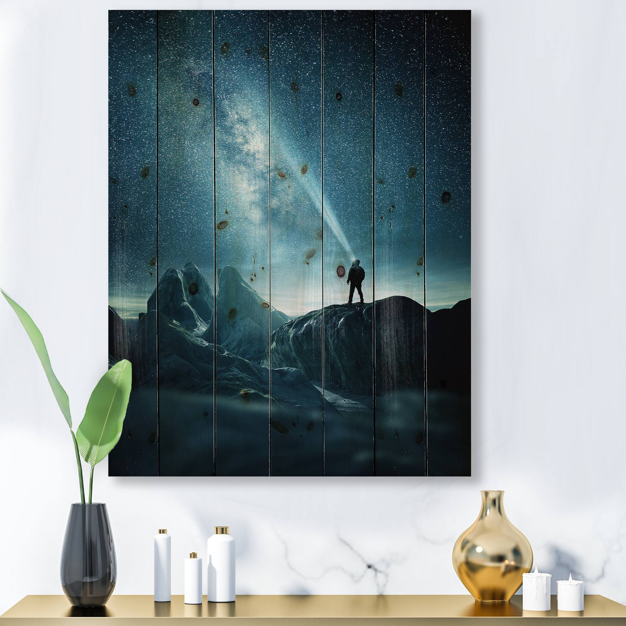 Designart - A Man Shining A Light Into The Night Sky